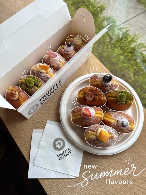 A colourful assortment of filled donuts in a box and on a plate